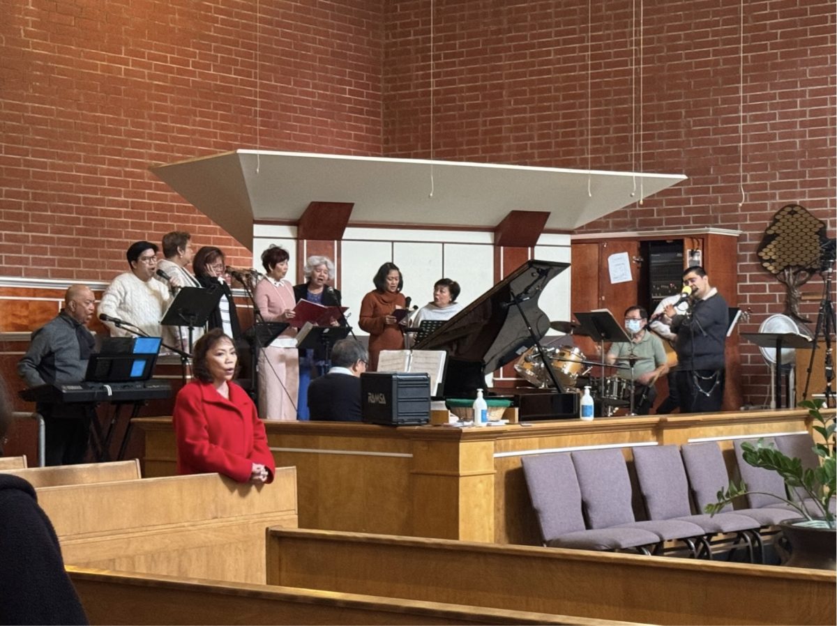 Rodette Deiresa (seventh from the left), Dennis Deiresa (pianist), and their fellow musicians lead the congregation in worship, invoking a desire to sway with the rhythm, tap your feet at the beat, sing the hymns, and clap along to the notes. (Photo Credit: Mayfield Crier)